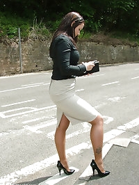 Sexy brunette in a tight skirt, with long stockinged legs..